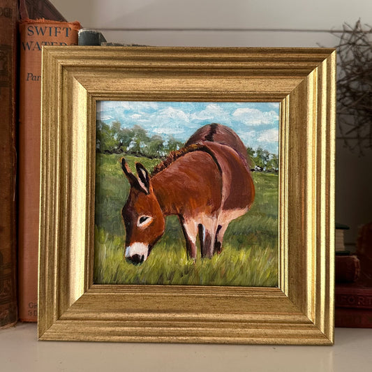 Grazing Donkey in a Field of Green